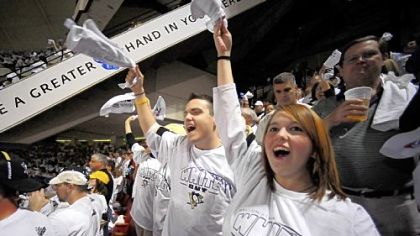 Ticket winners David Peters, center, and Erica Preffer cheer on the home team.