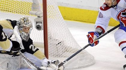 Marc-Andre Fleury makes a save on the Canadiens' Maxim Lapierre in the first period of Game 5 Saturday at Mellon Arena.
