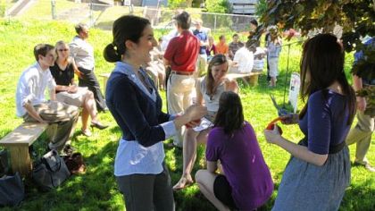 Camille O'Connor, a senior English and psychology double major, laughs as the ribbon is set up for the dedication of the outdoor classroom at the YMCA in Hazelwood. The project was done by the students in Duquesne University's Honors College.
