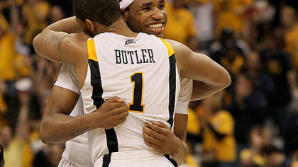 West Virginia's Da'Sean Butler and Kevin Jones celebrate during the second half of a 69-56 win in an East Region Sweet 16 game at the Carrier Dome in Syracuse, N.Y., Thursday.