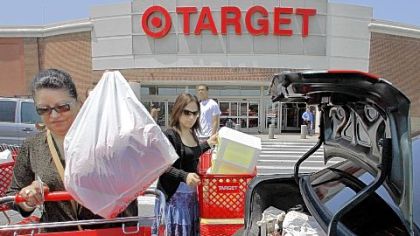 Shoppers load packages into their car after shopping at a Target. A monthly consumer survey shows that Americans' confidence in the economy eroded further in July amid job worries.