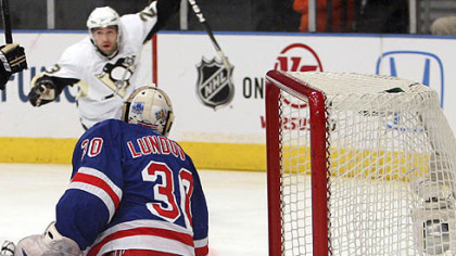 Rangers goaltender Henrik Lundqvist watches the puck as Penguins Chris Conner celebrates a goal during the first period.