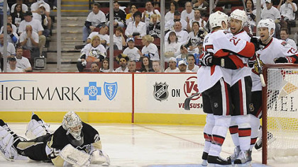 Penguins goaltender Marc-Andre Fleury lies on the ice as Senators forward Chris Neil, left, Chris Kelly, center and Jarkko Ruutu celebrate a second period goal Wednesday at Mellon Arena.