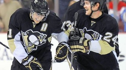 Matt Cooke, right, congratulates Evgeni Malkin after Malkin scored in the shootout against the Red Wings Sunday.