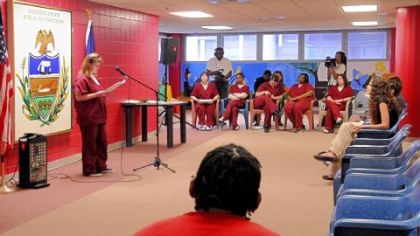 Allegheny County Jail inmate Terra Lynn reads her final presentation, telling of her home life for her creative writing classmates at the jail.