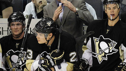 Standing behind forwards Matt Cooke, left, Alexi Ponikarovsky, center and Tyler Kennedy, Penguins coach Dan Bylsma calls a timeout during the third period of Tuesday's game against the Capitalsat Mellon Arena.