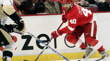 Red Wings forward Henrik Zetterberg rushes the puck up ice during the second period.