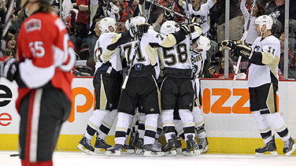 The Penguins celebrate forward Pascal Dupuis' overtime goal in Saturday's game at ScotiaBank Place in Ottawa.