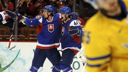 Slovakia defenseman Andrej Sekera, right, celebrates with teammate Richard Zednik following a goal Wednesday night.
