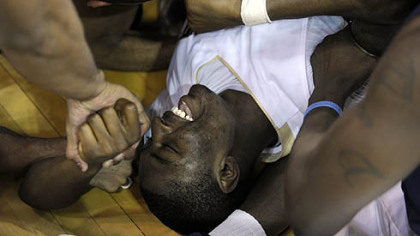 Pitt's Ashton Gibbs is mobbed by teammates after making a last-second shot to win the game.