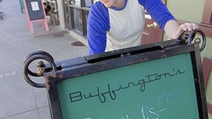 Katie Keller erases a sign Saturday promoting a Roethlis-burger lunch special at Buffington's, one of the bars Ben Roethlisberger went to Thursday in Milledgeville, Ga.