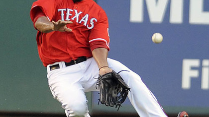 Rangers outfielder Nelson Cruz goes for a ball hit by the Pirates' Neil Walker during the first inning.