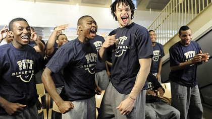 Travon Woodall, left, Ashton Gibbs, center, and Gary McGhee celebrate with their Panther teammates over Pitt's seeding.