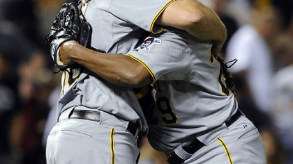 Pirates catcher Erik Kratz gives a hug to relief pitcher Octavio Dotel after beating the Rockies, 4-2.
