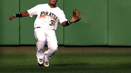 Pirates center fielder Jose Tabata makes a sliding catch on a ball hit by the Brewers' Jim Edmonds.
