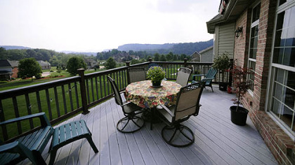 The deck offers fine views of a nearby valley and a hillside covered with Blue Rug juniper.