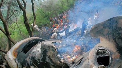 Pakistani rescue workers search for survivors amid the wreckage of a crashed jetliner on Wednesday on the outskirts of Islamabad.