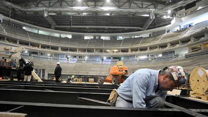 Ironworker Bob Beatty, of Wexford, puts together a portion of the video display last month inside the new Consol Energy Center.