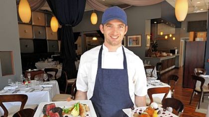 Sous chef Dan Carlton of Nine on Nine Restaurant, Downtown, with prime strip steak, left, and ricotta fritters.