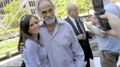 Sissy Dillon, 27, of Oakdale, has her picture taken with comedian Tommy Chong at Mellon Square in Downtown on Wednesday. Mr. Chong was in town for his show, "Laugh 'til You're Blue," presented by the Allegheny County Democratic Committee. In the background  is Cyril Wecht, the former coroner.