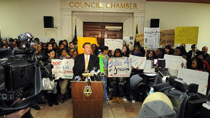 Black Political Empowerment Project Chairman Tim Stevens is joined by CAPA students in front of Pittsburgh City Council chambers.