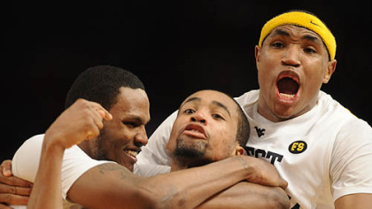 West Virginia's Da'Sean Butler, center, is mobbed by teammates Devin Ebanks, left, and Kevin Jones after shooting the game-winning 3-point basket over Cincinnati's Lance Stephenson in the second half of quarterfinal game in the Big East tournament at Madison Square Garden in New York, Thursday.