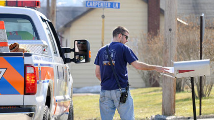 Volunteer Fire Capt. Dave Baumgarten from Elizabeth Township distributes flood preparedness information on Thursday along Heath Street in the township's Industry neighborhood, a flood-prone area along the Youghiogheny River.