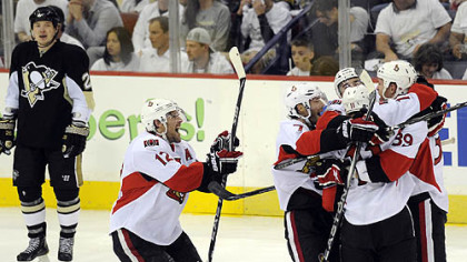 The Senators celebrate defenseman Matt Carkner's overtime goal following Game 5 at Mellon Arena, Thursday.