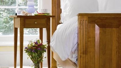 A solid cherry Summerset Bed is manufactured by Gat Creek Caperton Furniture Works in Berkeley Springs, W.Va.