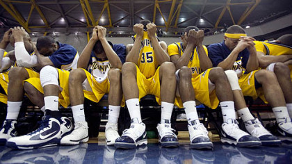 Quinnipiac's players sit on the bench while Robert Morris celebrates.
