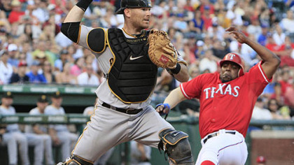 Pirates catcher Ryan Doumit turns to throw to first base as the Rangers' Vladimir Guerrero slides in on the bases-loaded force-out play at home plate during the second inning.