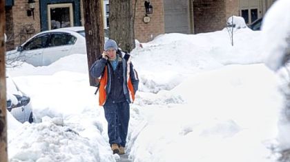 Jonathan Wilson, a sophomore at the University of Pittsburgh, walks a narrow sidewalk path on Clyde Street in Oakland on Wednesday.