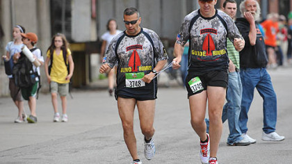 Cpt. Ivan Castro, left, who is blind, runs tethered to Lt. Col Fred Dummar, at the start of the wheelchair group. Both are Green Beret officers in the Army Special Operation Recruiting Battalion, Fort Bragg, N.C. Castro was blinded and suffered multiple wounds, including two collapsed lungs during a mortar attack in September 2006 in Iraq. This is their eighth marathon.