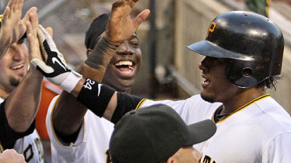 The Pirates' Delwyn Young, right, celebrates with teammates after hitting a three-run homer off Brewers pitcher Randy Wolf in the fourth inning.