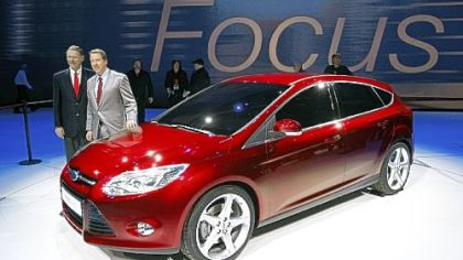 Ford Motor Co. CEO Alan Mulally, left, and Ford Motor Co. Executive Chairman William Ford Jr., pose next to the next-generation Ford Focus 5-door at the North American International Auto Show yesterday in Detroit.