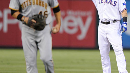 The Rangers' Josh Hamilton waves to the crowd after doubling in the second inning. The Pirates' Garrett Jones looks on.