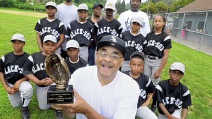 Ron Hill shows off the MVP trophy he will give to a player on the Wilkinsburg Black Sox baseball team that he sponsors.  Mr. Hill discovered that his great uncle, John Preston Hill, is the Pete Hill who was named to the Baseball Hall of Fame in 2006, but his name is incorrectly recorded on the plaque in Cooperstown.