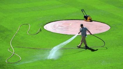Groundskeeper Matt Gerhardt waters the infield last week.