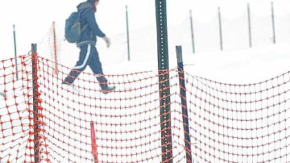 A lone hiker headed toward Millvale takes the detour of the North Shore Trail at the 31st Street Bridge through the remaining snow pack. The trail is detoured to accommodate the railroad track realignment needed for the reconstruction of Route 28.