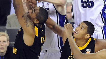 Duke's Brian Zoubek reaches for a rebound over West Virginia's Da'Sean Butler and Wellington Smith in the second half of the semifinal game in the NCAA tournament in Indianapolis last night.
