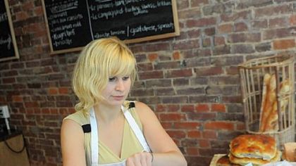 Jaclyn Davis, 22, works behind the counter at La Gourmandine, a French bakery on Butler Street in Lawrenceville.