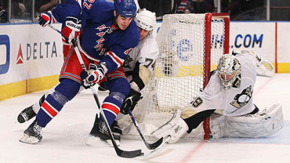 Rangers forward Brian Boyle has the puck poked away by Penguins goaltender Marc-Andre Fleury as defenseman Jay McKee gives chase.