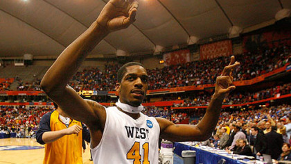 West Virginia's John Flowers celebrates as he walks off the court following the game.