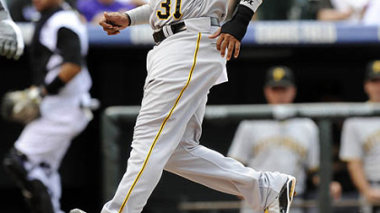 The Pirates' Jose Tabata scores on a wild pitch by Rockies pitcher Jorge De La Rosa in the first inning.