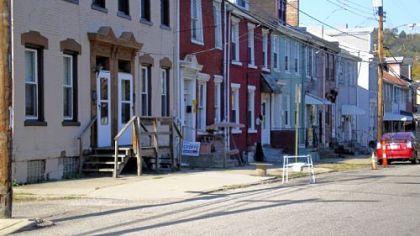 A portable toilet reserves a parking space on 39th Street in Lawrenceville last October.