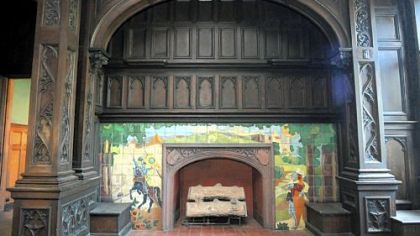 The grand hall's huge fireplace features a scene with a castle and two knights, one of whom is on a rearing black horse. The mansion has 11 fireplaces.