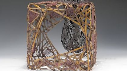 "Constraint" by Jane Herrick -- made of reed, waxed linen, blck ash and graphite -- was lashed, knotted, woven and formed over an armature.