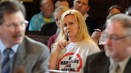 Elizabeth Schneider, of Lincoln Place, where Marcellus Shale drilling is being proposed, listens to speakers at City Councilman Doug Shields' post-agenda meeting in City Council chambers Monday afternoon.