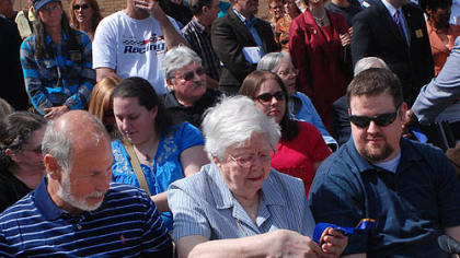 Russell Miller, left, the brother of Jeffrey Miller, and Florence Schroeder, the mother of William Schroeder, look at pieces of ribbon from the Monday ceremony on the Kent State campus, which named  the site where William Schroeder, Jeffrey Miller, Allison Krause and Sandra Scheuer were killed by the Ohio National Guard on May 4, 1970, to the National Register of Historic Places. At right is David Tuttle, William Schroeder's nephew.