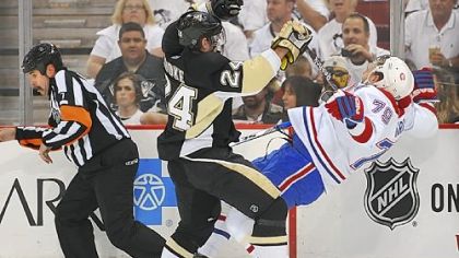 The Penguins' Matt Cooke checks the Canadiens' Andrei Markov into the boards in Game 1 of the Eastern Conference semifinal Friday at Mellon Arena.